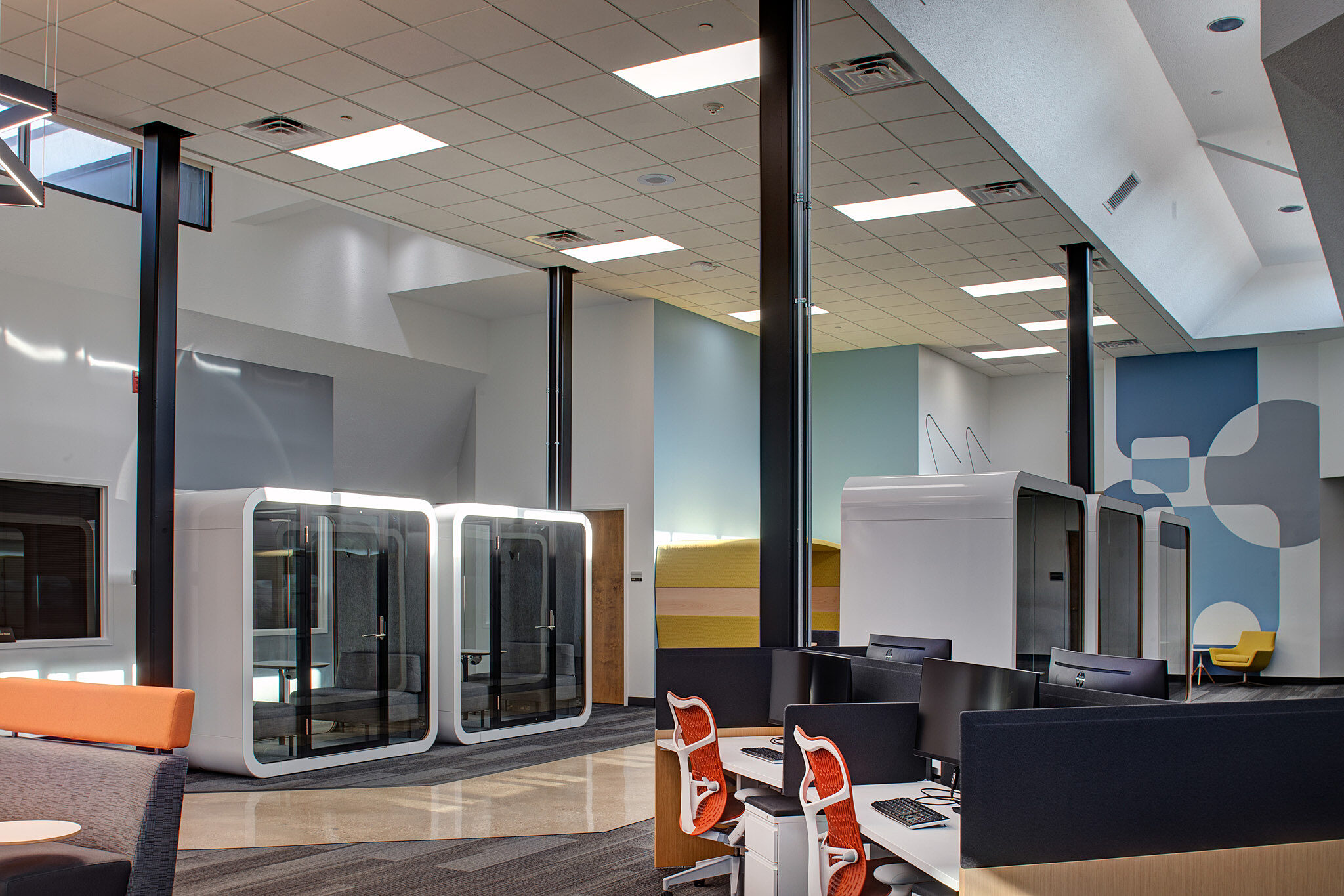 interior image of open area with workstations and pods