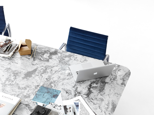 marble conference table and blue eames executive chairs
